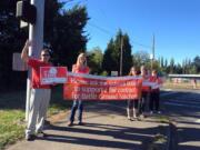 Battle Ground teachers, who had been without a contract since Sept. 1, wave banners last year in support of a fair contract.