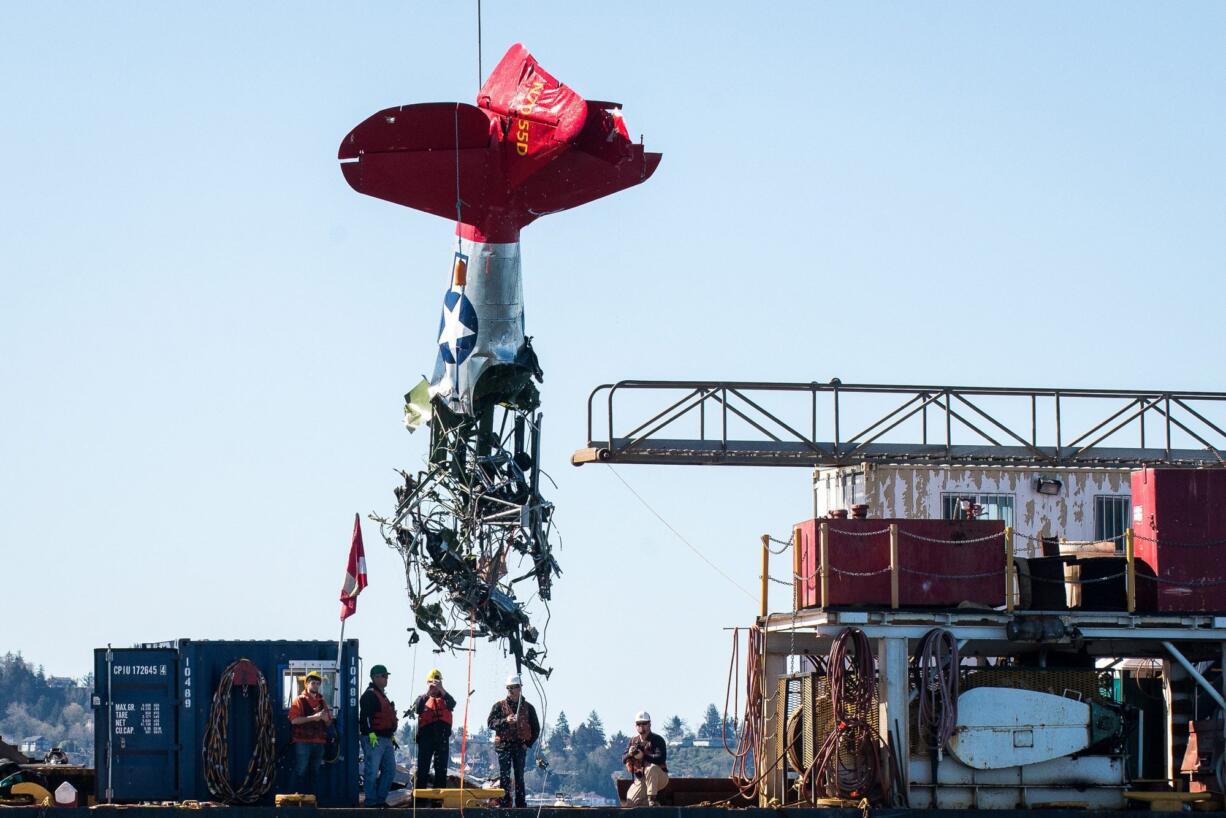 Crews remove the wreckage of John McKibbin’s plane from the Columbia River near Astoria, Ore., on Tuesday. The 1941 North American AT-6A military trainer crashed into the river March 23 about a mile north of Astoria’s Pier 39.