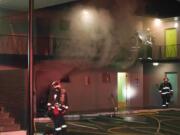 Firefighters from the Vancouver Fire Department respond Friday night to The Hudson Apartments, where a fire had been reported in a ground-floor studio.
