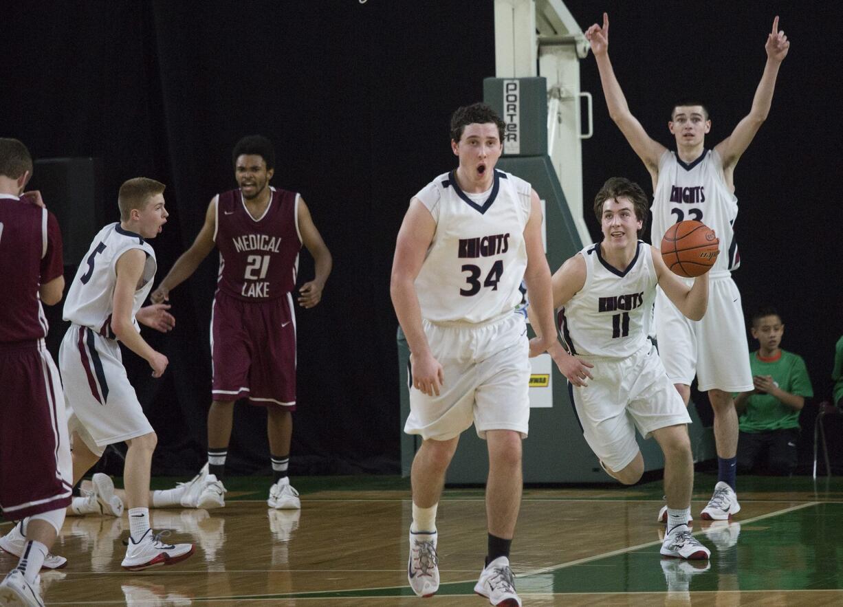 King's Way Christian's (l-r) Darion Lycksell, Preston Danberg, Karter Graves and Kienan Walter celebrate as King's Way defeats Medical Lake High School 47-45 in the  in the state class 1A boys' basketball tournament March 3, 2016 in the Yakima SunDome.