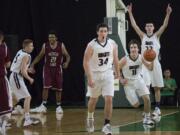 King's Way Christian's (l-r) Darion Lycksell, Preston Danberg, Karter Graves and Kienan Walter celebrate as King's Way defeats Medical Lake High School 47-45 in the  in the state class 1A boys' basketball tournament March 3, 2016 in the Yakima SunDome.