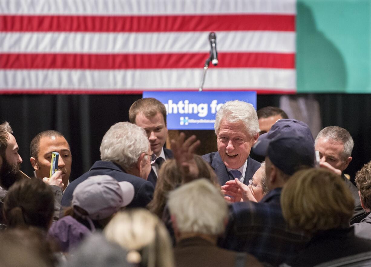 Former President Bill Clinton shakes hands with the crowd Monday while campaigning for his wife, Hillary Clinton, at Clark College in Vancouver.