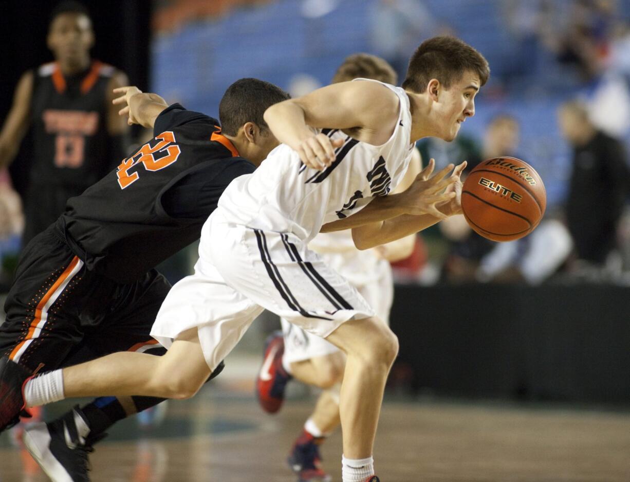 Union's Tyler Combs, right, steals the ball from Lewis and Clark's Isaiah Hernandez during action in the consolation bracket of the 4A Boys State Basketball Championship Friday, March 4, 2016, in Tacoma, Wash. Union won in overtime 78-71 to advance.