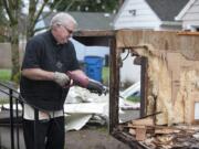 The Rev. David Knudtson of Arnada Abbey takes apart a trailer that will be converted into mobile showers.