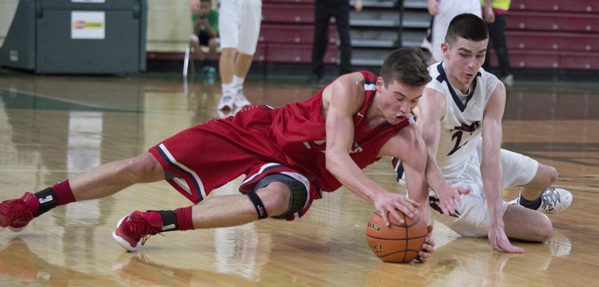 King's Corey Kispert, left, and King's Way Christian's Kienan Walter dive for a loose ball in the second quarter of their game in the state boys class 1A basketball tournament March 4, 2016 in the Yakima SunDome in Yakima, Wash.