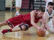 King's Corey Kispert, left, and King's Way Christian's Kienan Walter dive for a loose ball in the second quarter of their game in the state boys class 1A basketball tournament March 4, 2016 in the Yakima SunDome in Yakima, Wash.