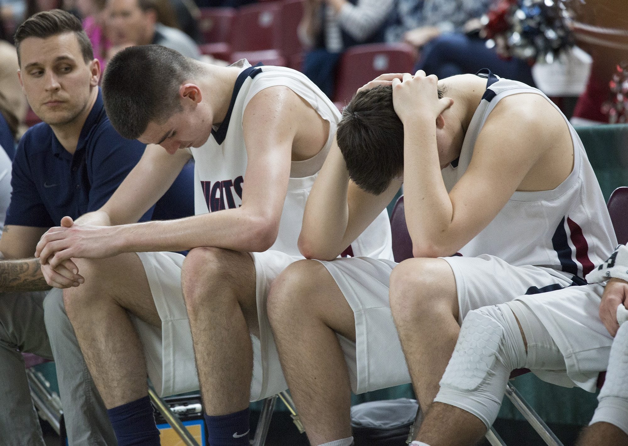 King's Way Christian's Kienan Walter, center, and Joe Mills, right, sit dejected on the bench in last minutes of the fourth quarter of their 59-31 loss to King's High School in the state boys class 1A basketball tournament March 4, 2016 in the Yakima SunDome in Yakima, Wash.