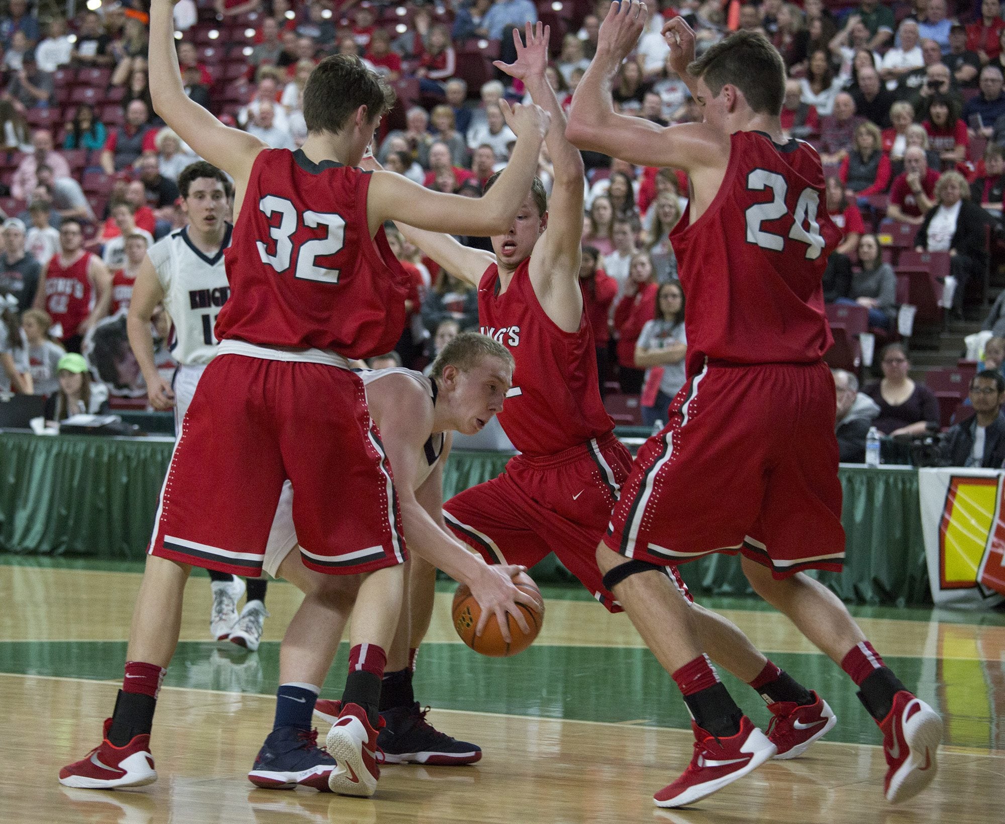 King's Way Christian's Skyler Freeman is surrounded by King's  defenders as he drives to the basket in the second quarter of their game in the state boys class 1A basketball tournament March 4, 2016 in the Yakima SunDome in Yakima, Wash.