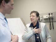 Sharon Parks of Ryderwood talks with Dr. Nathan Boyer, an interventional cardiologist, during a follow-up appointment Tuesday at The Vancouver Clinic. Last month, Boyer performed a new procedure, called transcatheter aortic valve replacement, on Parks to replace a diseased aortic valve.