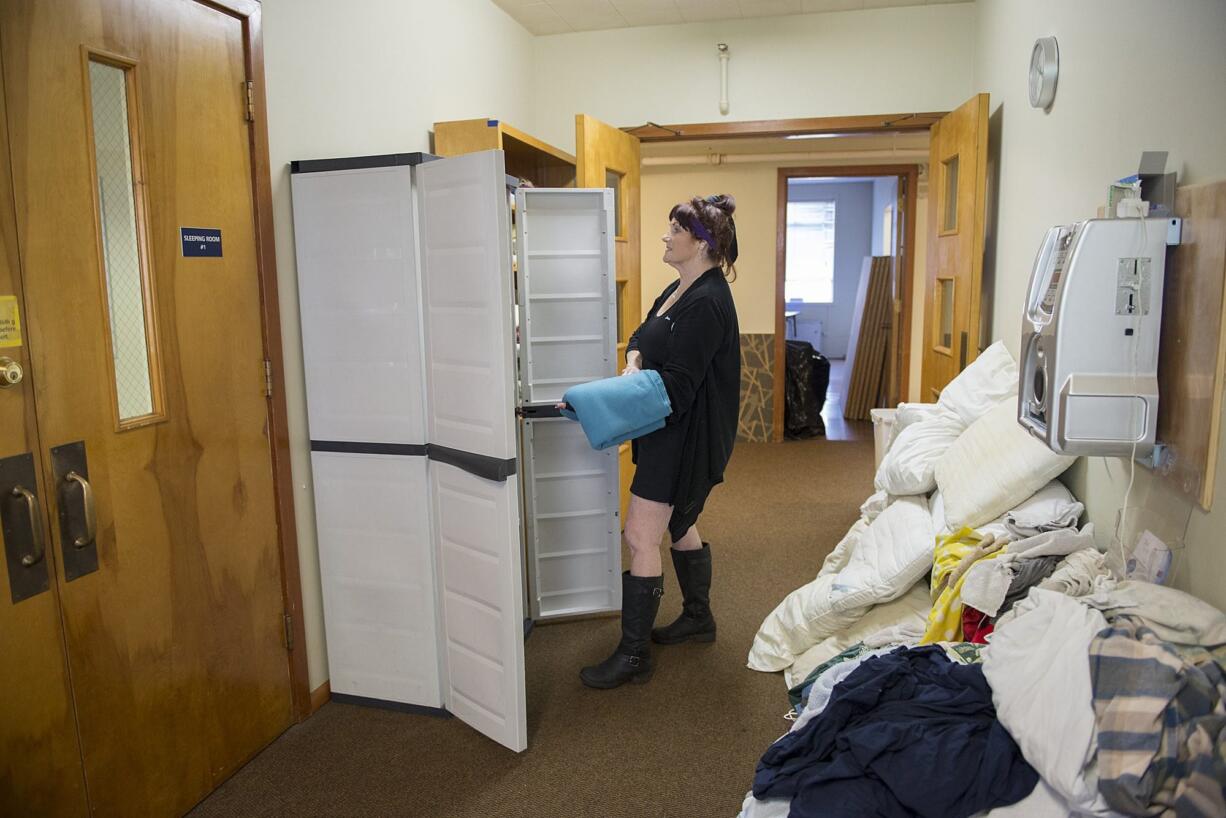 Connie Hewitt organizes clean bedding to be used by women staying overnight in St. Paul Lutheran Church&#039;s former Sunday school building.