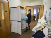 Connie Hewitt organizes clean bedding to be used by women staying overnight in St. Paul Lutheran Church&#039;s former Sunday school building.