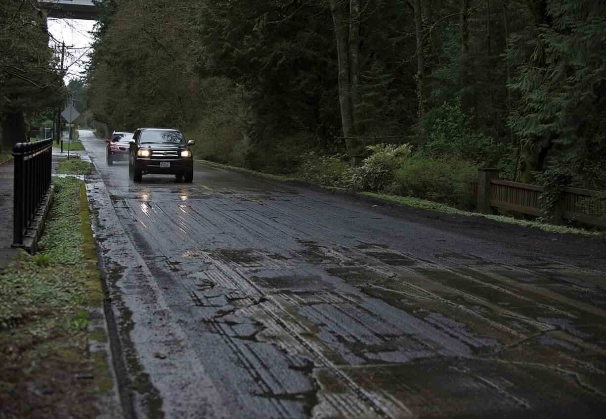 Motorists rumble over a rough stretch of Evergreen Highway near the intersection of Southeast 113th Court on Monday afternoon.