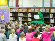 Woodland: Shae Lindsay, school librarian, wears a tree costume while reading &quot;The Giving Tree&quot; to students as part of the Reading is Fundamental Program.