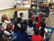 Rose Village Neighborhood: Fort Vancouver Lion Wanda Slevin reads to students at Washington Elementary.