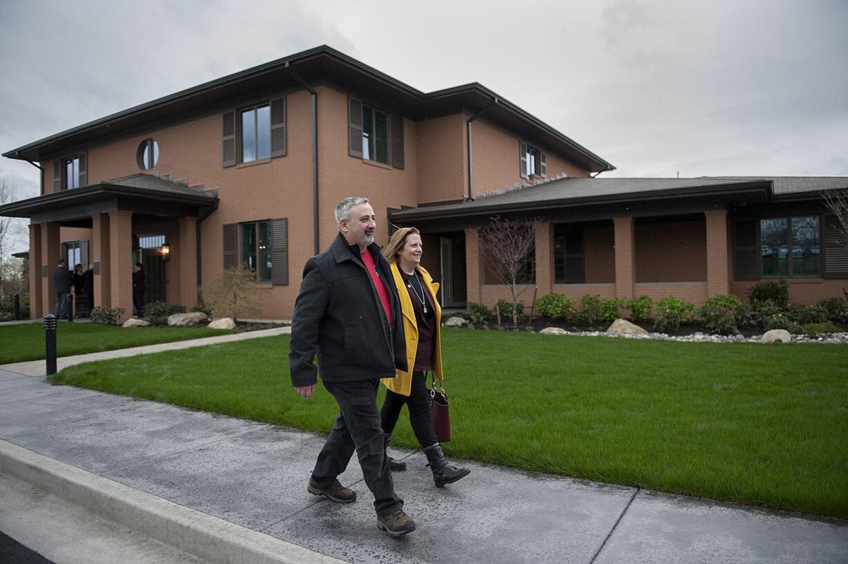 Tracy and Teresa Phillips leave the new Fisher House after attending the dedication ceremony Wednesday. The Fisher House program aided the family after their nephew, Sgt. John Kyle Daggett, was mortally wounded in Iraq in 2008. The family made a $10,000 donation to the program in his memory.