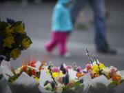 Kia Lor of C&amp;K&#039;s Flower Garden puts together a bouquet for a customer during the opening weekend of the Vancouver Farmers Market in 2014.