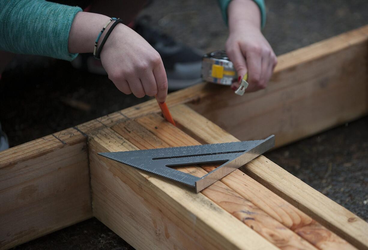 Evergreen High School students in the Geometry in Construction class help construct a Habitat for Humanity house in March 2016.