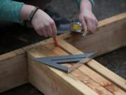 Evergreen High School students in the Geometry in Construction class help construct a Habitat for Humanity house in March 2016.