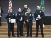 Officer Lee Gelsinger, from left, receives the Vancouver Police Department&#039;s Lifesaving Award on Tuesday night from Chief James McElvain; Cpl. Drue Russell and Officer Christopher Douville also received the award.