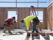 Juan Garcia, right, works Tuesday on framing a room at the Isabella Court apartment complex construction site in central Vancouver. A 180-unit apartment building is planned nearby at 5500 N.E. Fourth Plain Blvd.