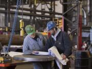 Thompson Metal Fab employees George Mason, left, and Mike Marsh look over shop drawings in 2016 at the company&#039;s Vancouver shop.