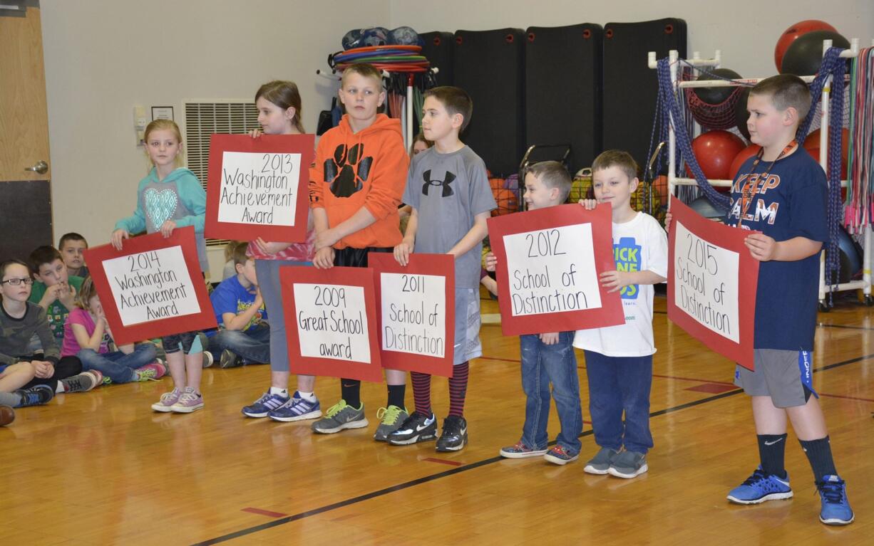 Washougal: From left to right, Ava Mortensen, Catherine Dewey, Garrett Mansfield, Bryce Devlin,Tyler Ryan, Halen Crane, and Jarod Barlow hold signs representing the years their school won &quot;School of Distinction&quot; award, as well as years they won &quot;Great Schools&quot; and &quot;Washington Achievement&quot; awards.