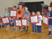 Washougal: From left to right, Ava Mortensen, Catherine Dewey, Garrett Mansfield, Bryce Devlin,Tyler Ryan, Halen Crane, and Jarod Barlow hold signs representing the years their school won &quot;School of Distinction&quot; award, as well as years they won &quot;Great Schools&quot; and &quot;Washington Achievement&quot; awards.