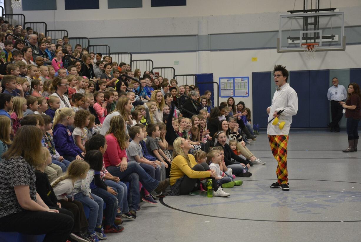 Washougal: Seattle prop comic, Alex Zerbe entertains kids at Gause Elementary.