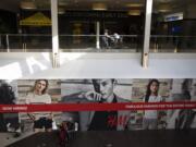 Shoppers on Thursday walk by the new Gold&#039;s Gym and H&amp;M stores under construction where Nordstrom once stood at the Vancouver Mall.