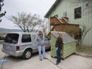 Cory Soderberg, left, talks with the Rev. Jessie Smith near his van and a hut for the homeless in the parking lot at St. Anne&#039;s Episcopal Church.