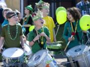 Hough Elementary School fourth-graders Spencer Smith, 9, left, and Summit Joling, 10, second from left, share a moment of joy behind the scenes with classmates as they wait for the 25th annual Paddy Hough Parade to begin Thursday in the Hough neighborhood.