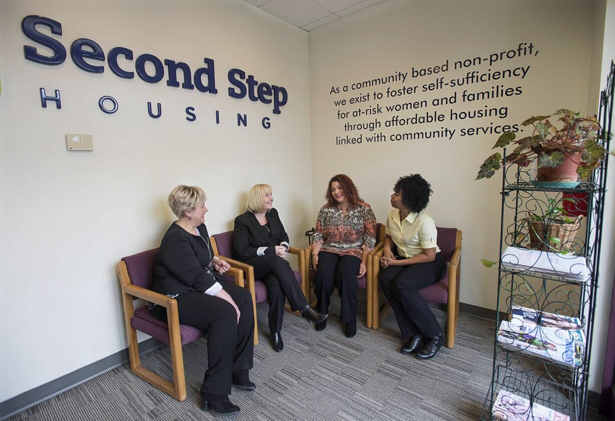 Denise Stone, from left, and Debby Dover of Second Step Housing chat with program client Amanda Owens and Armetta Burney of Clark College about their new partnership. The college can now directly refer homeless students to Second Step, which provides housing.