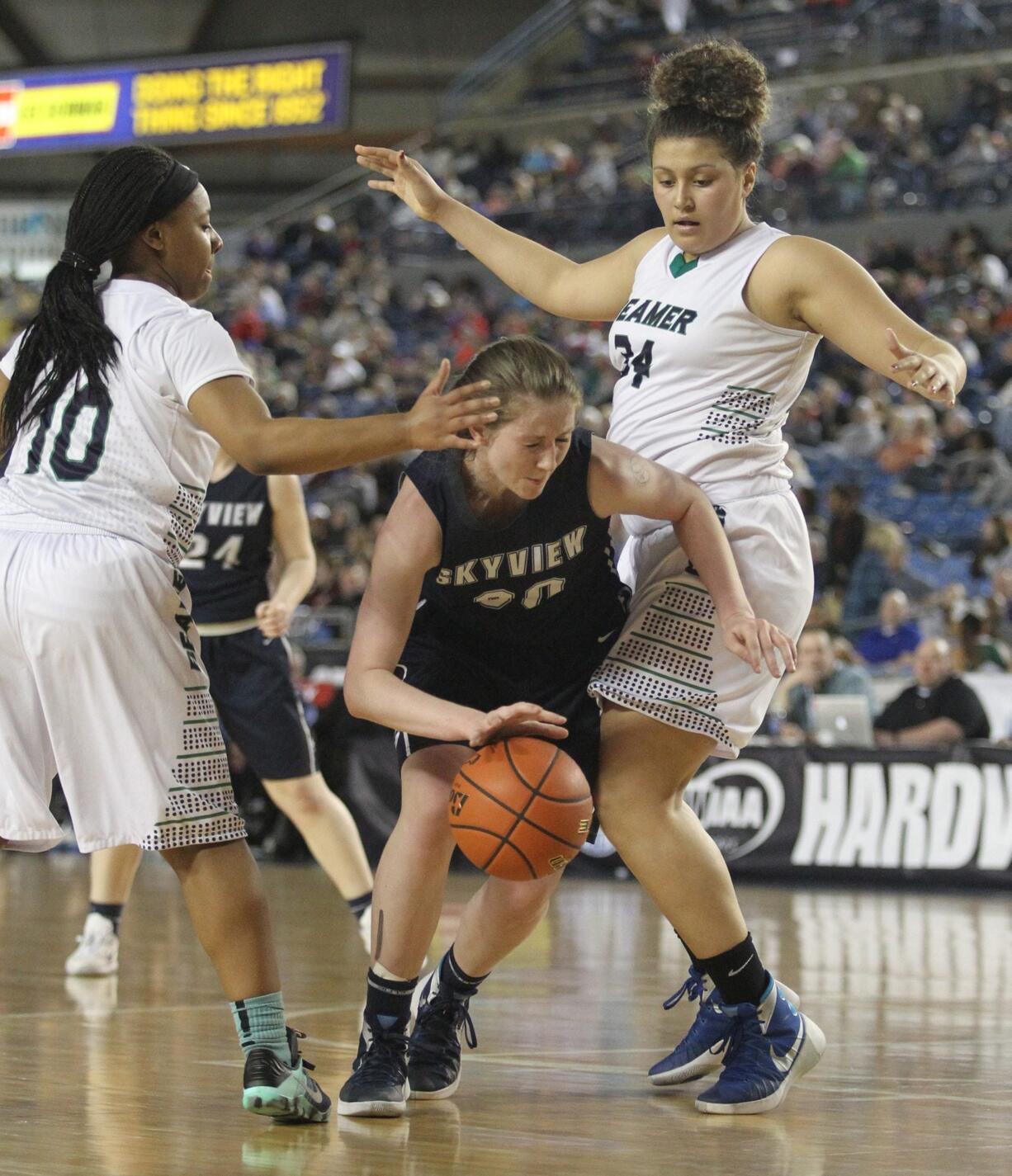 Skyview&#039;s Ashlee Comastro tried to dribble between Todd Beamer&#039;s Jahpera Mceachin (10) and Makenzie Bond (34) in a 2016 WIAA Girls 4A Hardwood Classic State Basketball game held in the Tacoma Dome on Mach 3, 2016. Todd Beamer beat Skyview 40-35.