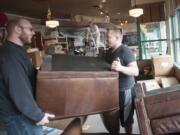 Steven Morgan, right, moves furniture with Wyatt McGehee as remodeling takes place at the Starbucks near Esther Short Park in Vancouver on Monday.