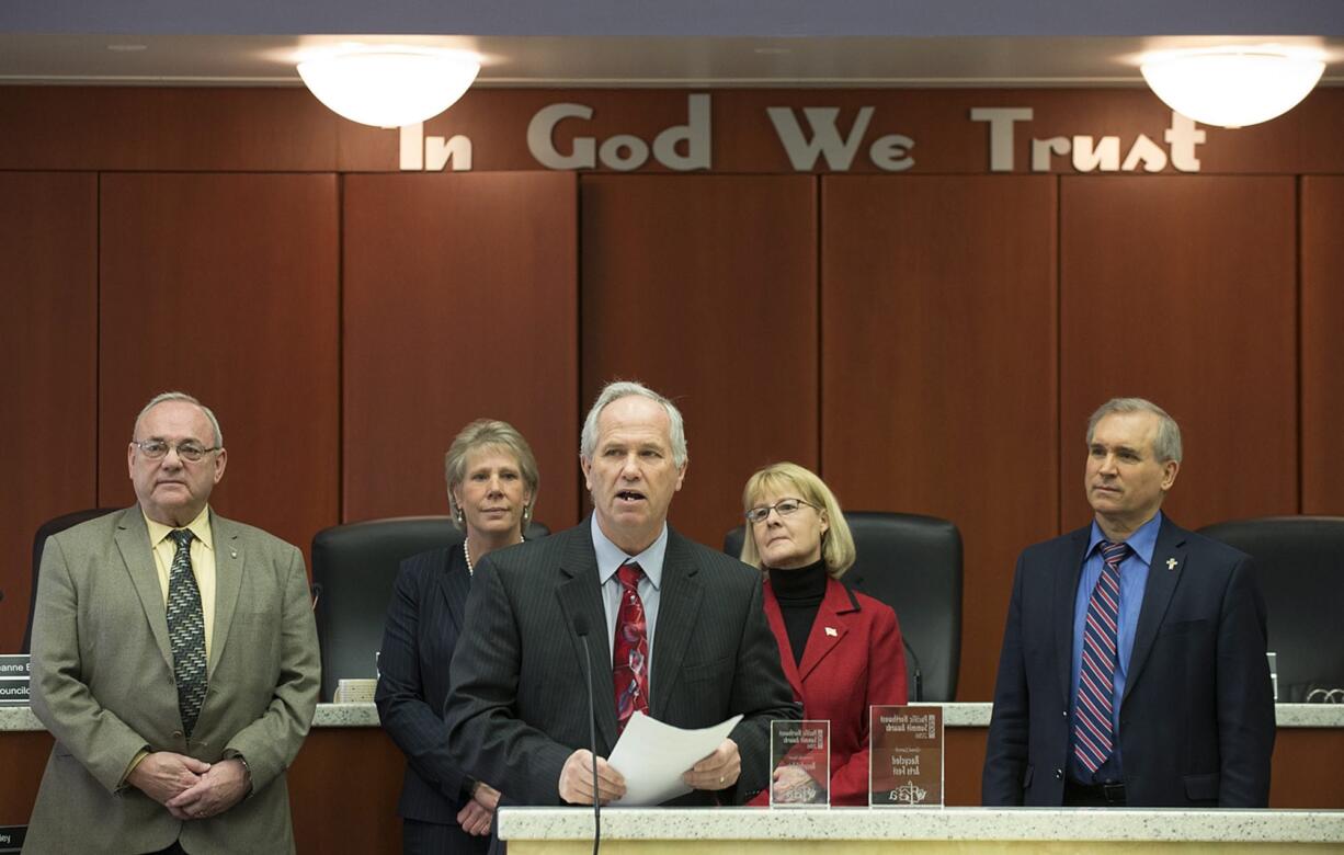 Clark County council Chair Marc Boldt, center, joins fellow Councilors Tom Mielke, from left, Julie Olson, Jeanne Stewart and David Madore to address the crowd March 22 at the Clark County Public Service Center.