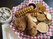 Coleslaw, chicken and waffles and garlic spuds are served at Kooky Chicken in Vancouver.