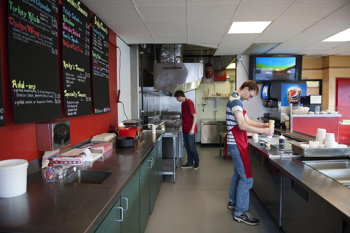 Co-owner Jessic Gombart, right, and his brother, Elliot Gombart, work March 22 at Kooky Chicken in Vancouver.