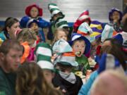 First-grader Jordan Terry, wearing green shirt and holding fork, is surrounded by a sea of Dr. Seuss hats as he eats his green eggs and ham Tuesday morning at Ellsworth Elementary School.