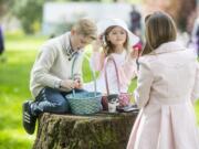 Gavin Hurt, 9, sorts his basket of eggs along with Jenna Warren, 4, and Katie Warren after the annual Easter Day Egg Hunt in Camas on April 5, 2015.