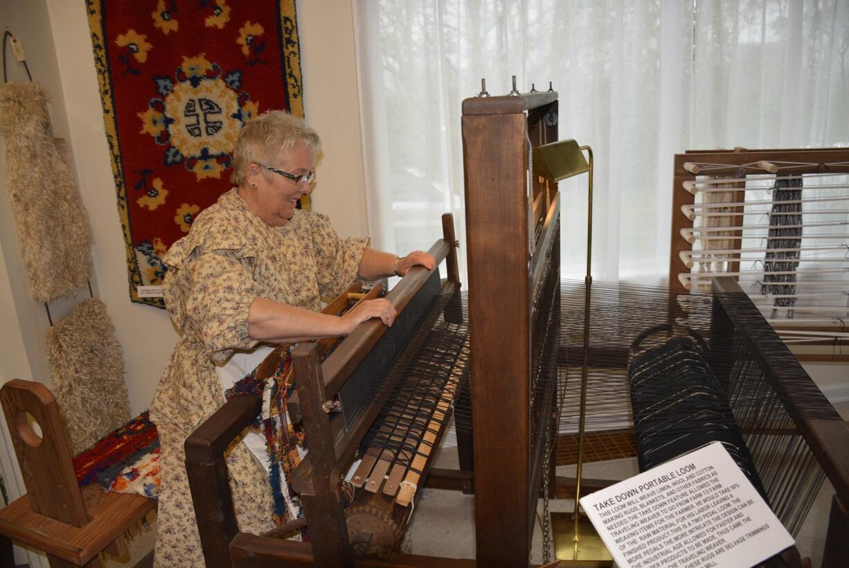 Washougal: Volunteer Karen Johnson uses a portable loom to create a woven rug.