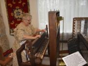 Washougal: Volunteer Karen Johnson uses a portable loom to create a woven rug.