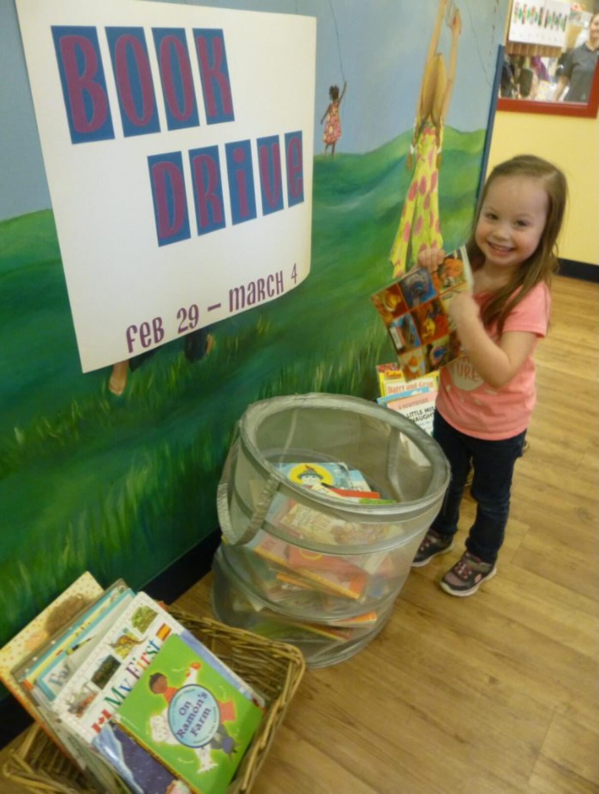 Salmon Creek: Preschooler Addy Wilson drops off a book for The Goddard School book drive.