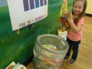 Salmon Creek: Preschooler Addy Wilson drops off a book for The Goddard School book drive.