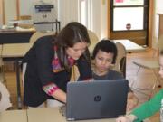 Fircrest: Shannon Gedo, EverFi schools manager, sets up a student with the new Digital Learning Program in the Salvation Army&#039;s Afterschool S.A.Y.