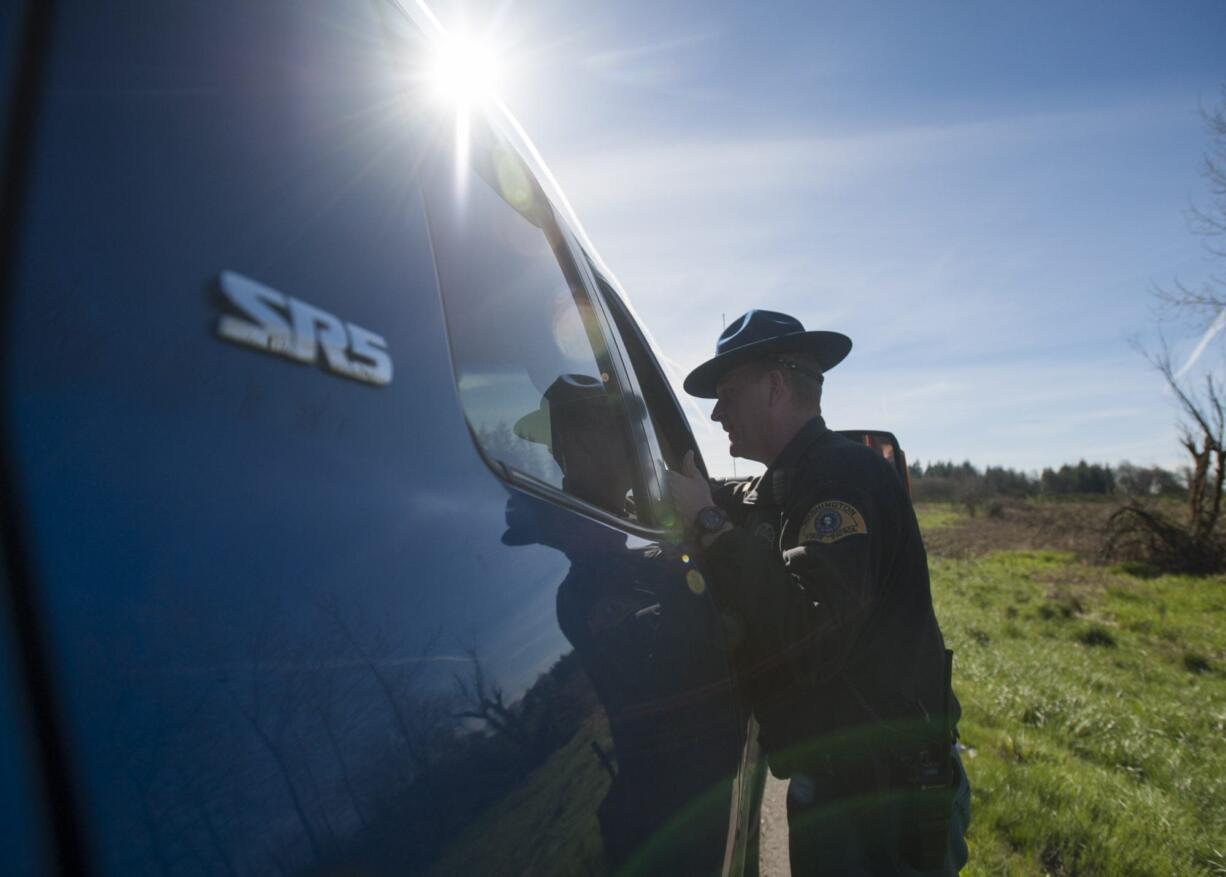 Washington State Patrol Trooper Will Finn talks to a driver Thursday morning during a three-day sting that targets left-lane violators on highways. Finn spent the day educating drivers on the law, which states that the left lane is intended to be used for passing only.