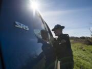 Washington State Patrol Trooper Will Finn talks to a driver Thursday morning during a three-day sting that targets left-lane violators on highways. Finn spent the day educating drivers on the law, which states that the left lane is intended to be used for passing only.