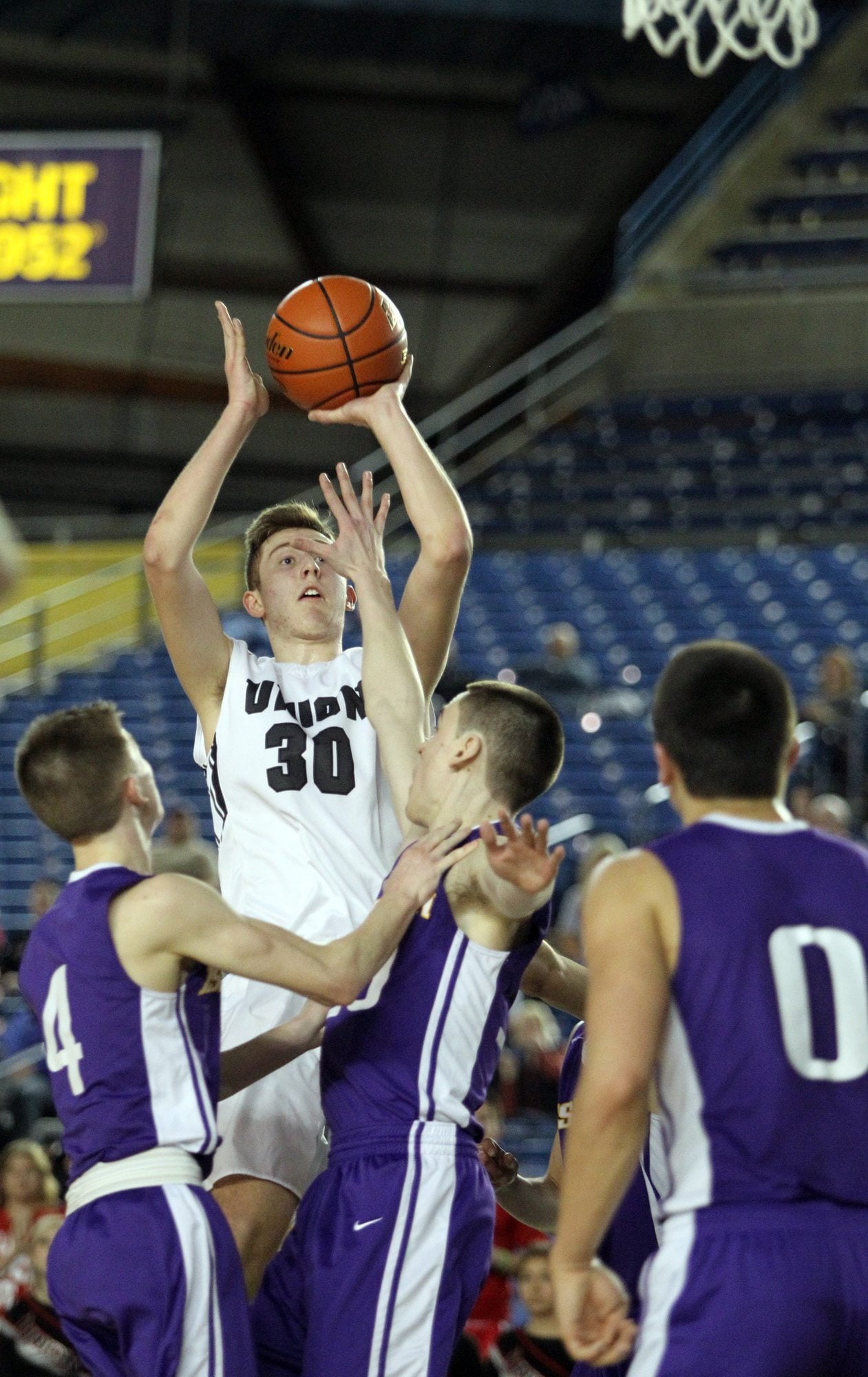 Union's Cameron Cranston (30) hits a jumpshot over defending Issaquah players Jason Crandall (4) and Ethan Hammond (30) in the 2016 WIAA Boys 4A Hardwood Classic State Basketball 4th place game held in the Tacoma Dome on March 5, 2016.  Cranston hit a game high of 20 points to help lead Union over Issaquah 60-57 for the 4th Place trophy.