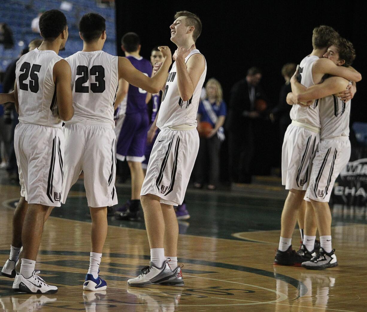 Union's Kai Gamble (25) and Christian Agarpo (23) celebrate with Cameron Cranston as Denis Kirichenko hugs Nico Bricker after their 60-57 win over Issaquah in the 2016 WIAA Boys 4A Hardwood Classic State Basketball 4th place game held in the Tacoma Dome on March 5, 2016.  Union beat Issaquah 60-57 for the 4th Place trophy.