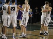 Union's Kai Gamble (25) and Christian Agarpo (23) celebrate with Cameron Cranston as Denis Kirichenko hugs Nico Bricker after their 60-57 win over Issaquah in the 2016 WIAA Boys 4A Hardwood Classic State Basketball 4th place game held in the Tacoma Dome on March 5, 2016.  Union beat Issaquah 60-57 for the 4th Place trophy.