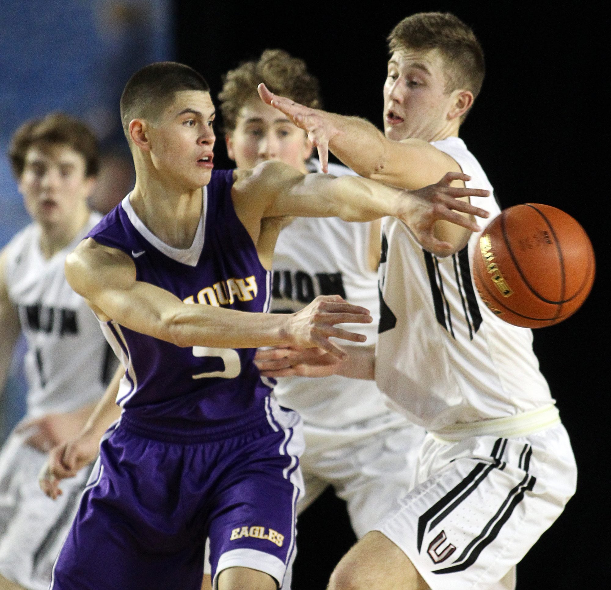 Union's Cameron Cranston, right, forces Issaquah's Trevon Ary-Turner (5) to pass the ball during the 2016 WIAA Boys 4A Hardwood Classic State Basketball 4th place game held in the Tacoma Dome on March 5, 2016.  Cranston high a game high of 20 points to help lead Union to a 60-57 victory over Issaquah for the 4th Place trophy.